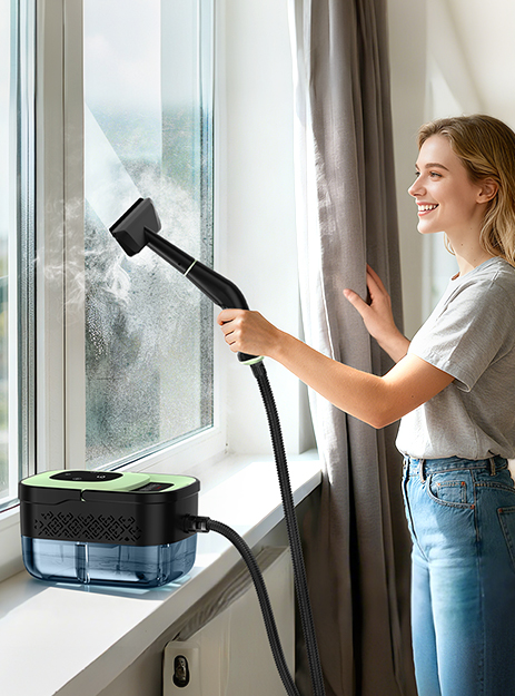 Green portable steam cleaner used on a window Green portable steam cleaner used on a window